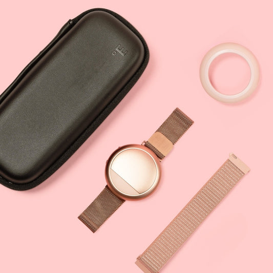 Embr Wave Rose Gold Bundle with Travel Case, Comfort Case, and Comfort Band on a pink background